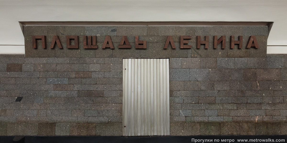 Фотография станции Площадь Ленина (Ленинская линия, Новосибирск). Название станции на путевой стене крупным планом. Шрифт подобран как на мавзолее Ленина на Красной площади в Москве.