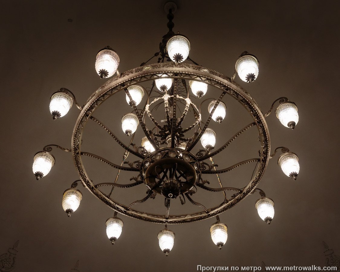 Фотография станции Нарвская (Кировско-Выборгская линия, Санкт-Петербург). Светильник в эскалаторном зале крупным планом. Люстра в центре зала.
