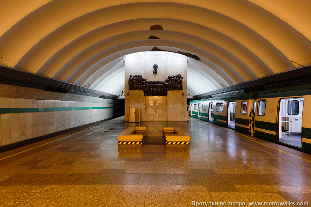 Фотография станции Обухово (Невско-Василеостровская линия, Санкт-Петербург). Противоположная от входа часть станции. Раньше здесь был ещё один светильник-торшер, но он был утрачен, и теперь эта часть станции вот уже долгие годы пребывает в полумраке.