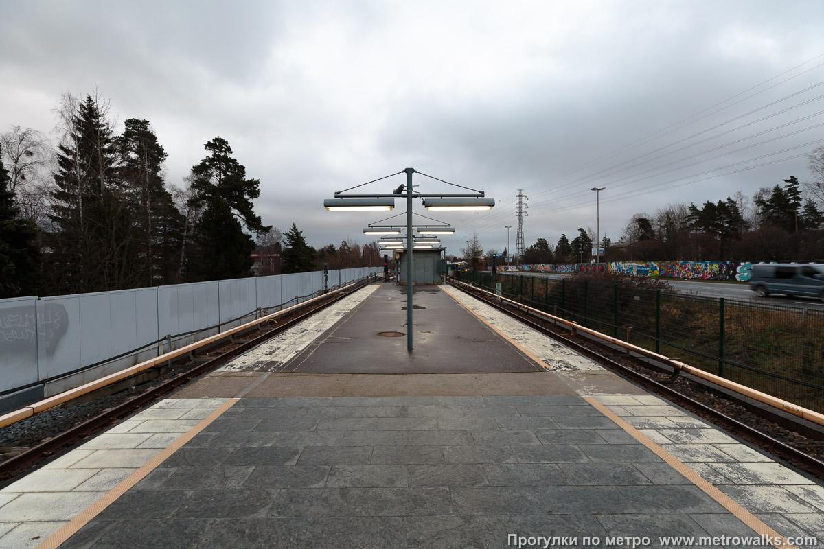 Фотография станции Kulosaari / Brändö [Ку́лосаа́ри] (Хельсинки). Противоположная от входа часть станции. Восточную оконечность платформы при реконструкции оставили нетронутой из-за сокращения длины поездов.